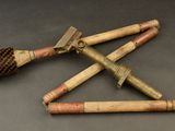 three old wooden tools are laying on a black surface