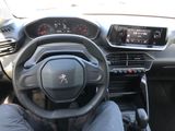 someone is sitting in the driver seat of a car with their feet on the steering wheel