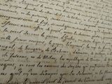 an old document with writing on it sitting on top of a table