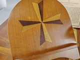 a wooden box with a cross on it on a table