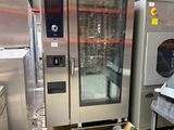several stainless steel ovens in a large industrial kitchen with lots of shelves