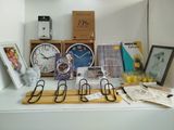 a shelf with a clock, picture frames, pictures, and other items on it