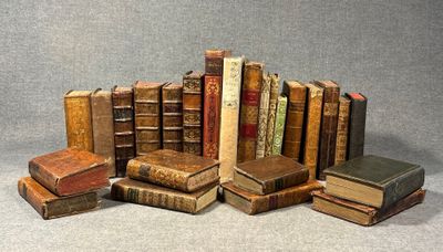 several old books are stacked on top of each other on a table