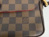 an image of a brown and black purse on a white surface