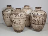 several vases are lined up in a row on a white surface