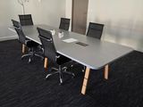 a conference room with a table and chairs in it