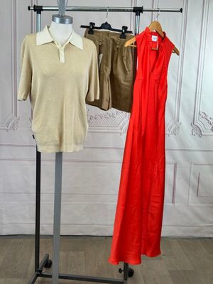 two dresses hanging on a clothes rack in a room