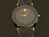 an image of a close up of a wrist watch on a black surface