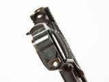 a close up of a gun that is on a white surface