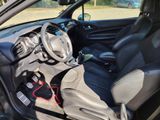 the interior of a small car with a steering wheel and dashboard