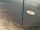 a close up of a car door with a sticker on it