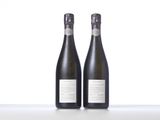 two bottles of wine sitting on top of a table