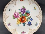 a close up of a plate with flowers and butterflies on it