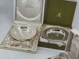three silverplated dishes and spoons in a box on a white surface