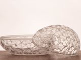 a glass bowl and a glass bowl on a table
