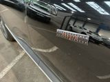 a close up of a car door handle with a sticker on it