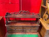 a wooden bench with drawers underneath it in a room