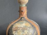 a bottle with a picture on it sitting on a table
