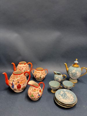 many different types of teapots and plates on the table