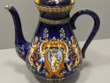 a blue and gold teapot with a lion on it
