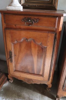 a wooden cabinet with a mirror on top of it