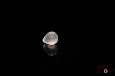 an image of a clear glass object on a black surface