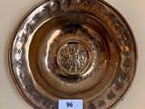 a silver plate with a picture of a man on it