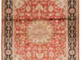 an orange and black rug with a medallion design on it