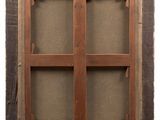 an old wooden window with a brown frame and brown fabric