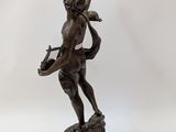 bronze statue of a cupid playing the harp on a marble base