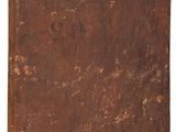 an old brown book sitting on top of a white surface