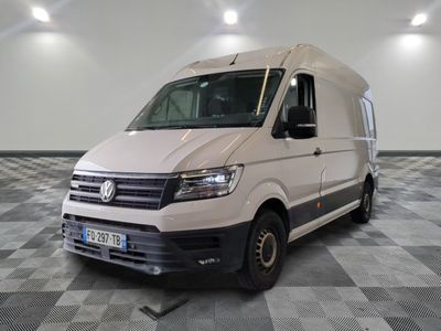 the white van is parked on a checkered floor in the garage