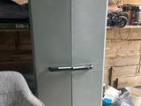a refrigerator and a chair in a room next to a chair