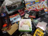 a pile of assorted toys and games on a table
