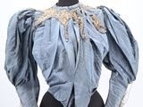 an image of a mannequin dress with a blue blouse on a mannequin mannequin