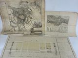 two old maps on a table with a pen and paper
