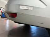 a sticker on the back of a car that is parked in a garage