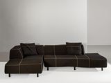 a large brown sectional couch sitting on top of a white floor