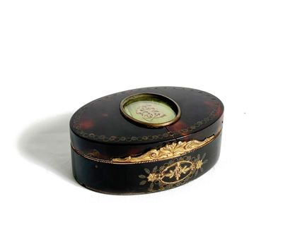 a black and gold box with a clock on it
