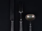 three forks and spoons with a knife and spoon on a black background