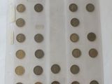 some coins are in a clear plastic bag on a white surface