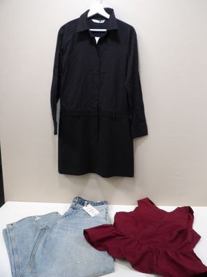 a black shirt, jeans, and a red shirt on a white table