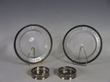 two silver and glass objects on a white surface
