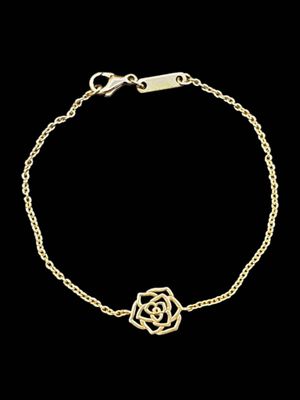 a gold plated bracelet with a flower on a chain