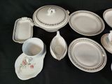 a lot of plates and cups on a black table