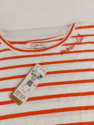 an orange and white striped t - shirt with a tag on it