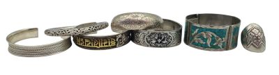 several different types of silver rings and bracelets on a white surface