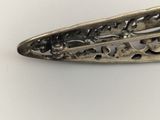a close up of a metal object on a white surface