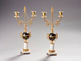 pair of gold and white candelabs with black and white vases
