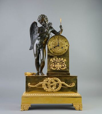 a statue of an angel holding a clock on a stand